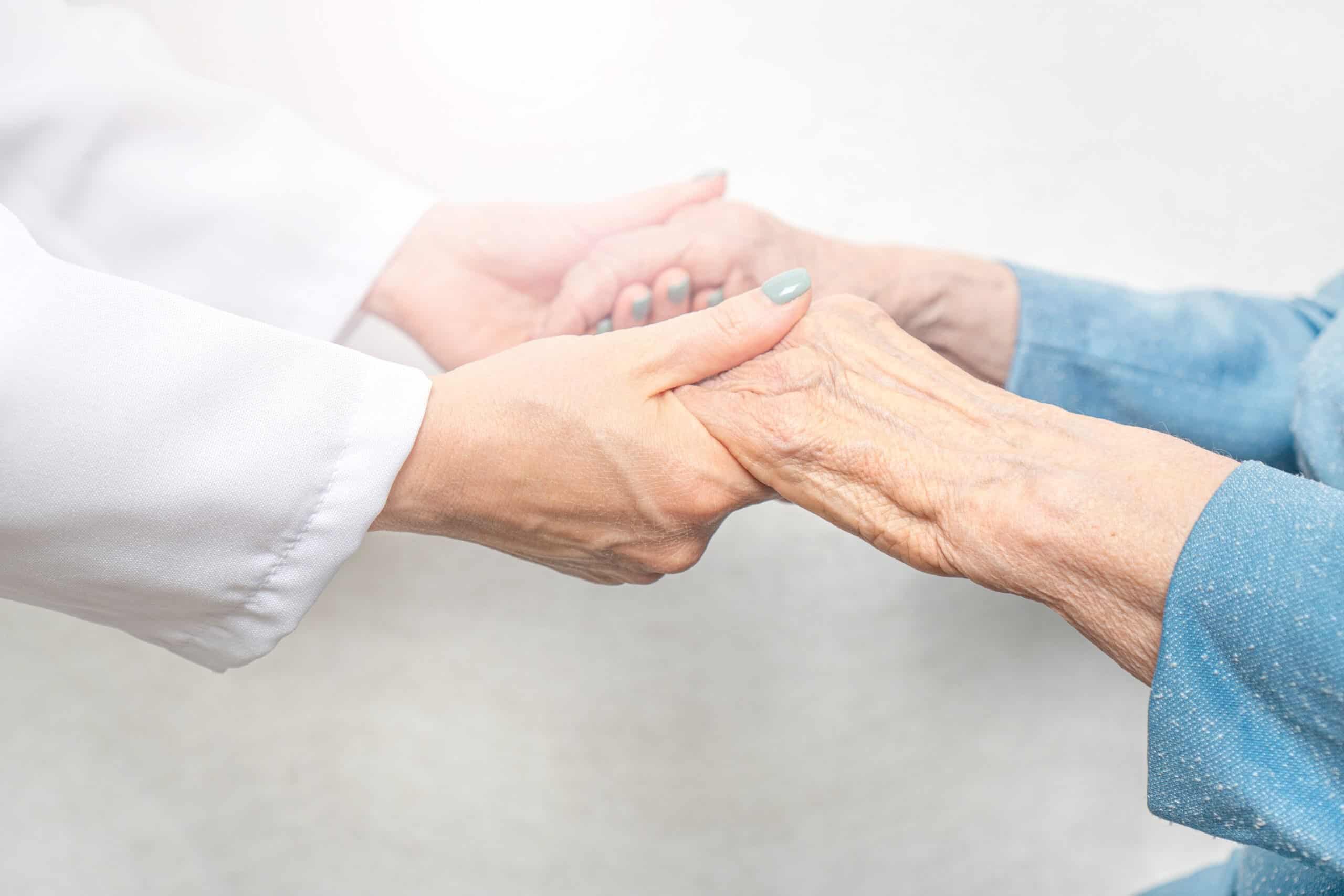 Caregiver holding a Seniors hands