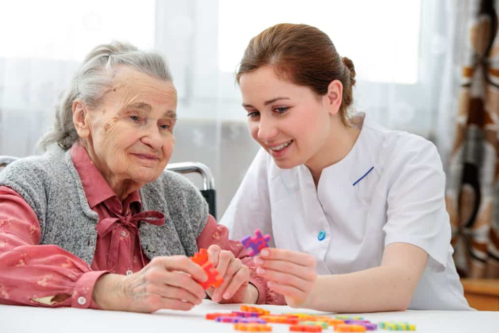 Memory care activity with care worker and resident 